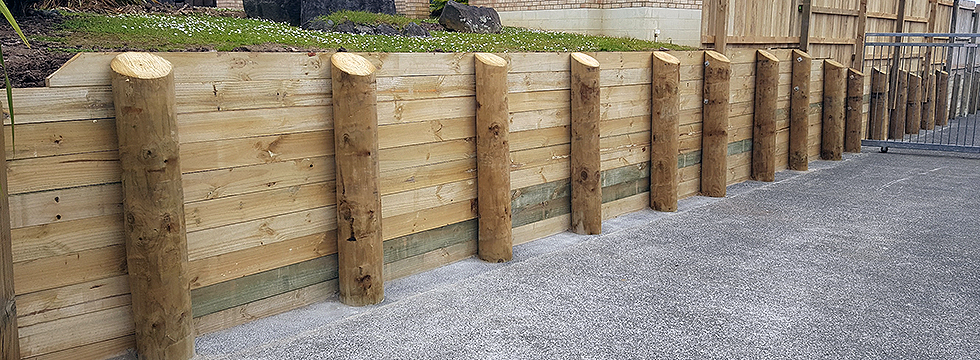 Timber retaining wall replaced alongside existing driveway in Auckland